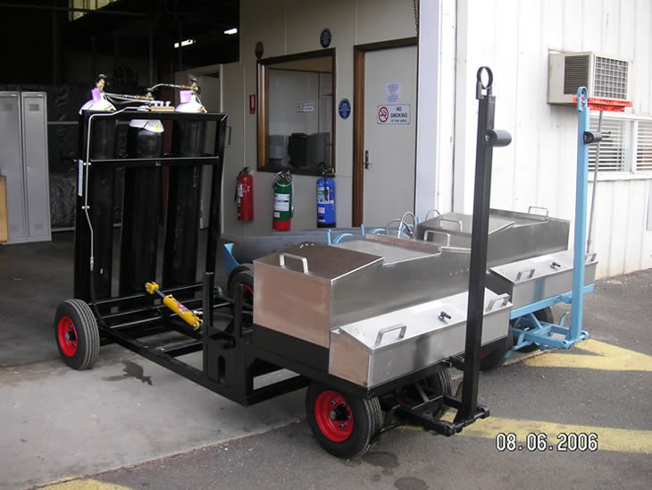 compressed gas bottle bottle cart with bottles lifted to standing position to enable replacment
