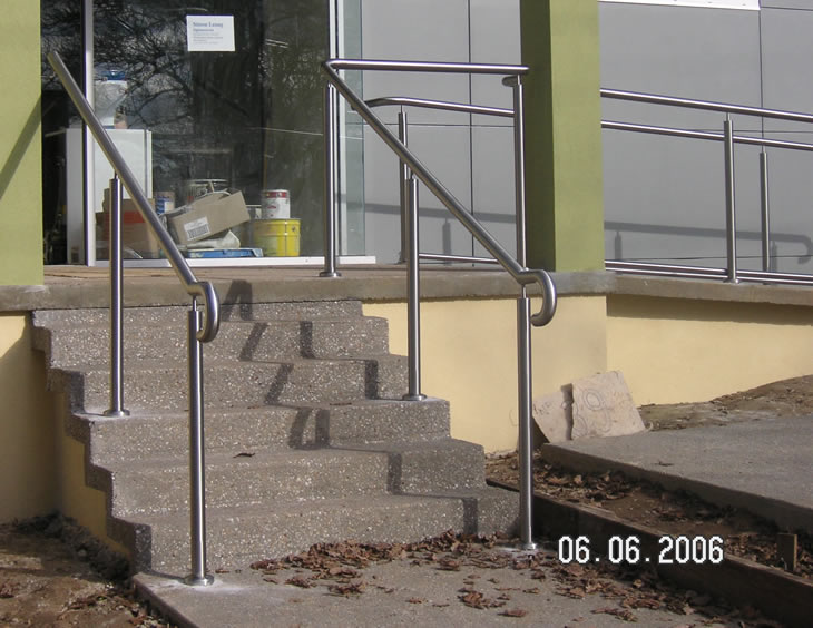 Stainless steel rails on concret steps and walking ramp