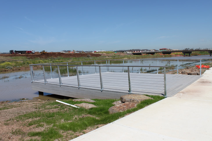Stainless steel rails around viewing platfor beside lake